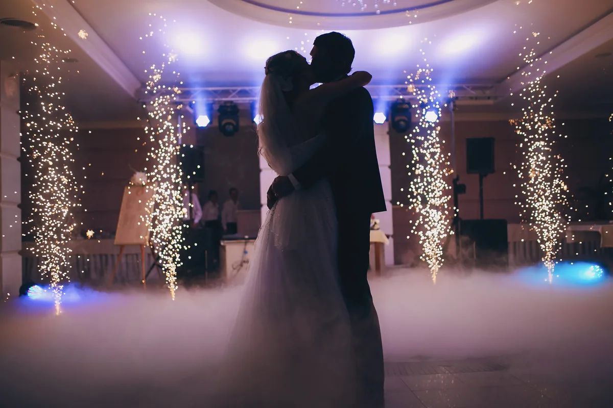 Newlyweds' first dance surrounded by sparkler fountains and low cloud effect